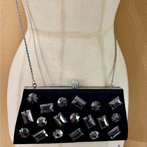 Black evening clutch with beautiful embellishment on satin fabric